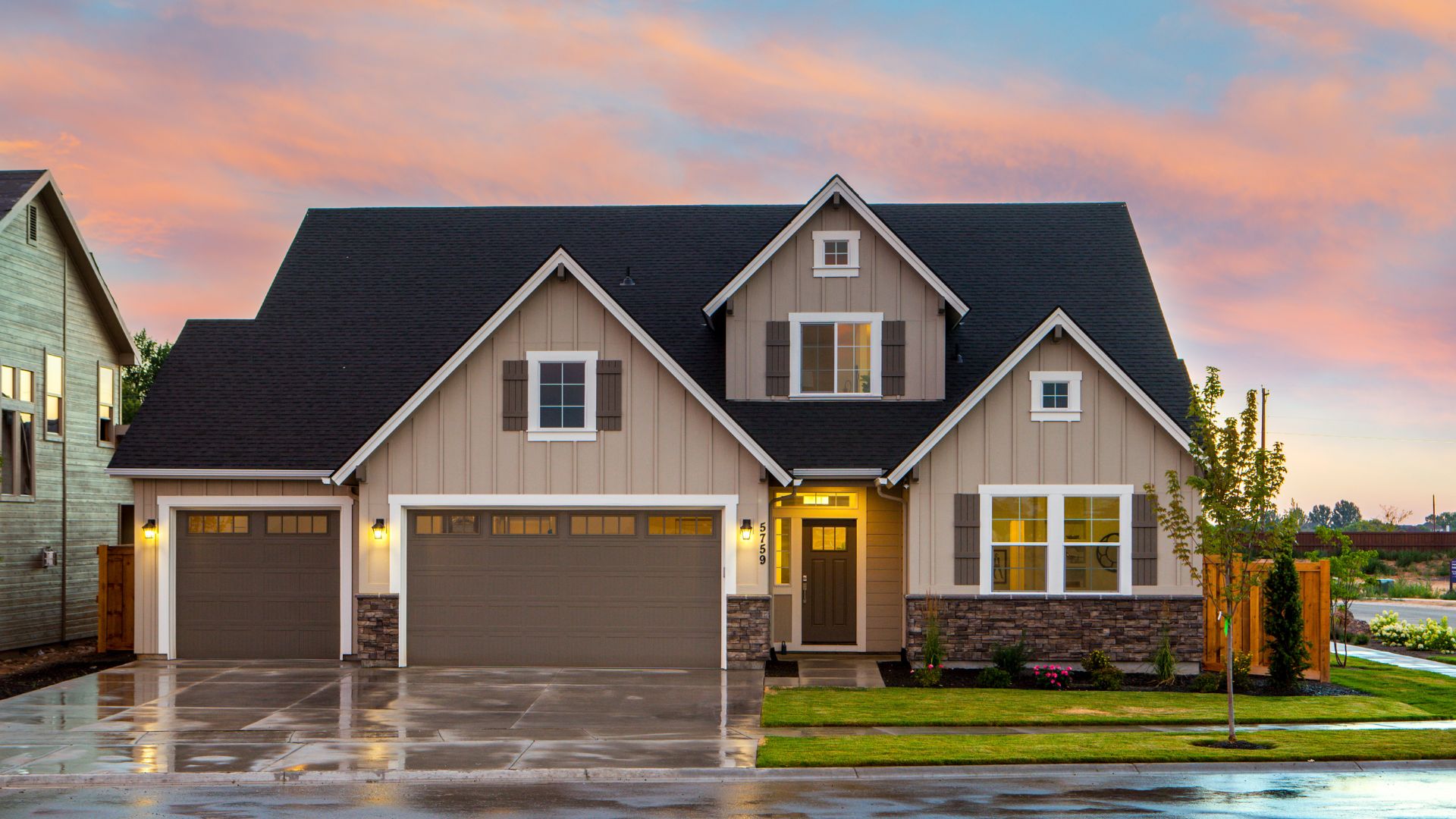 A large house with two garages in front of it