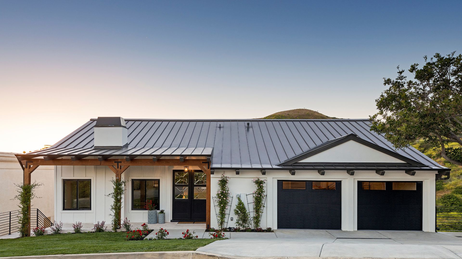 A white house with a black garage door