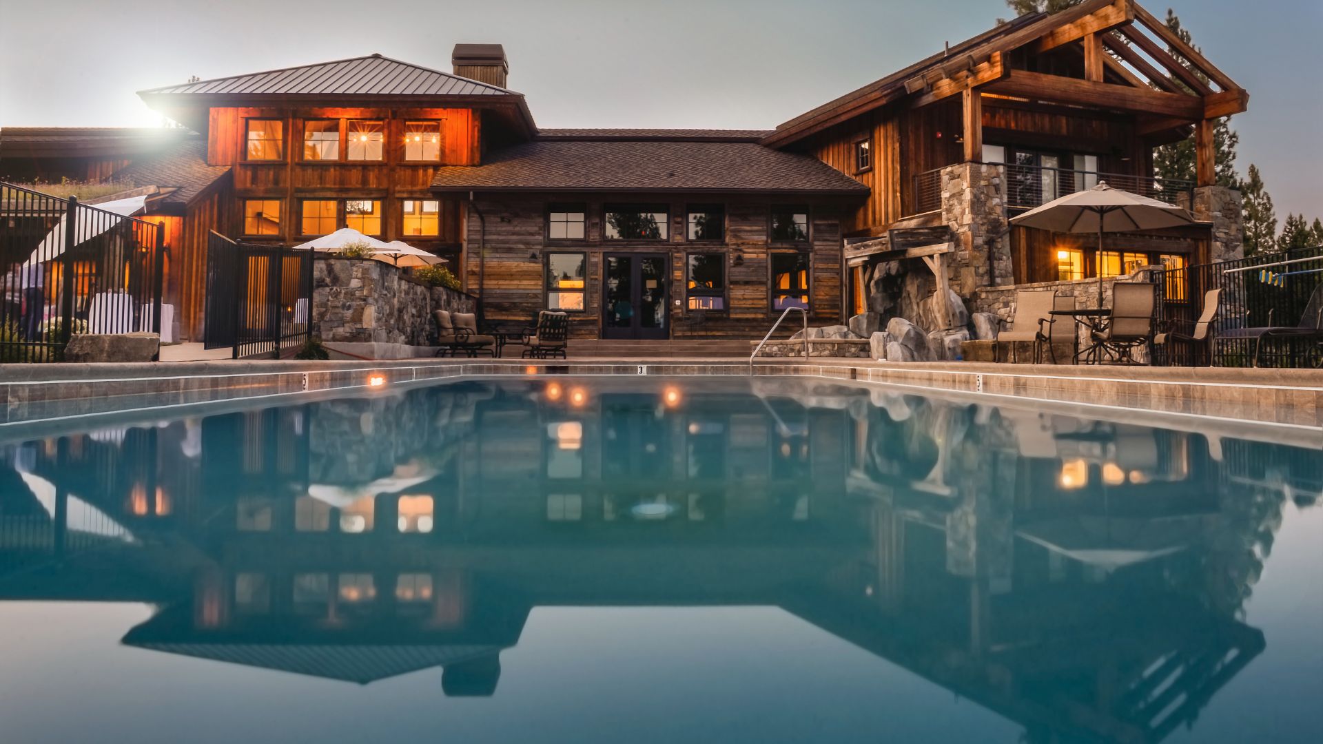 A large house with a pool in front of it