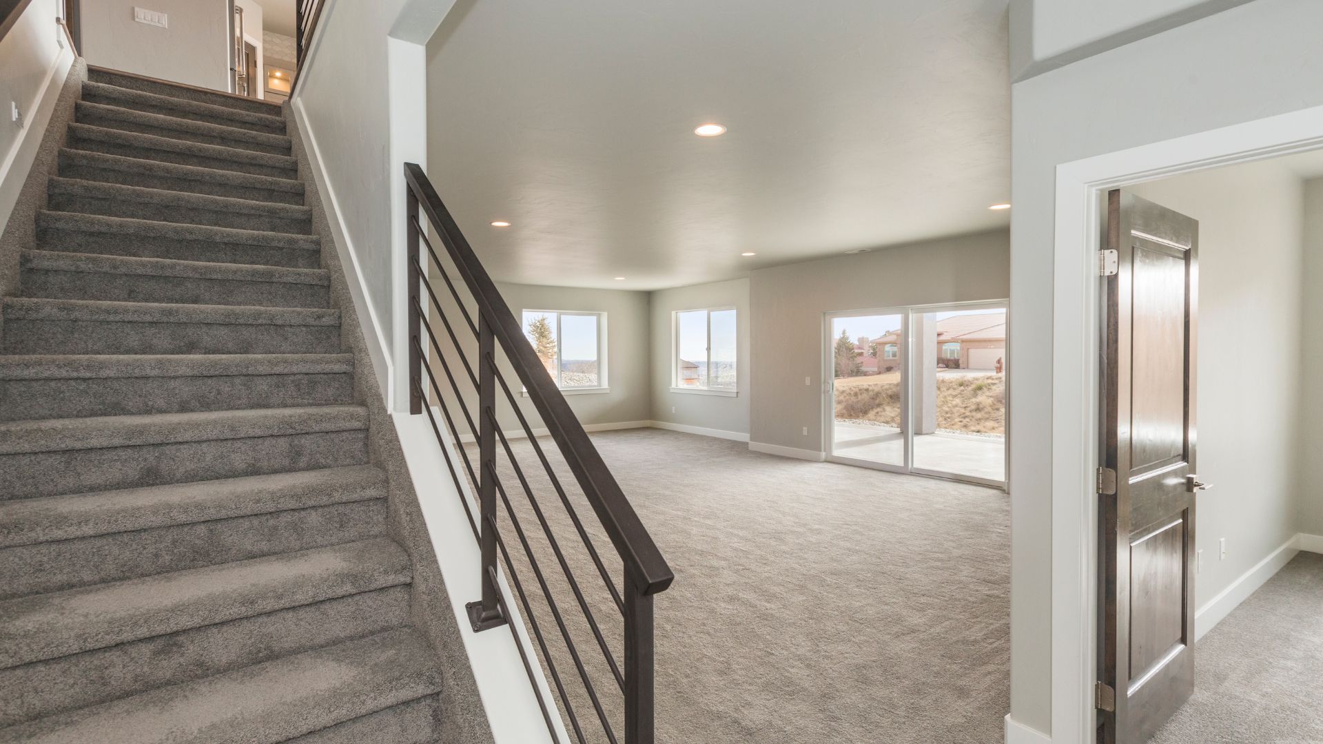 A large open floor plan with a staircase leading to a second story