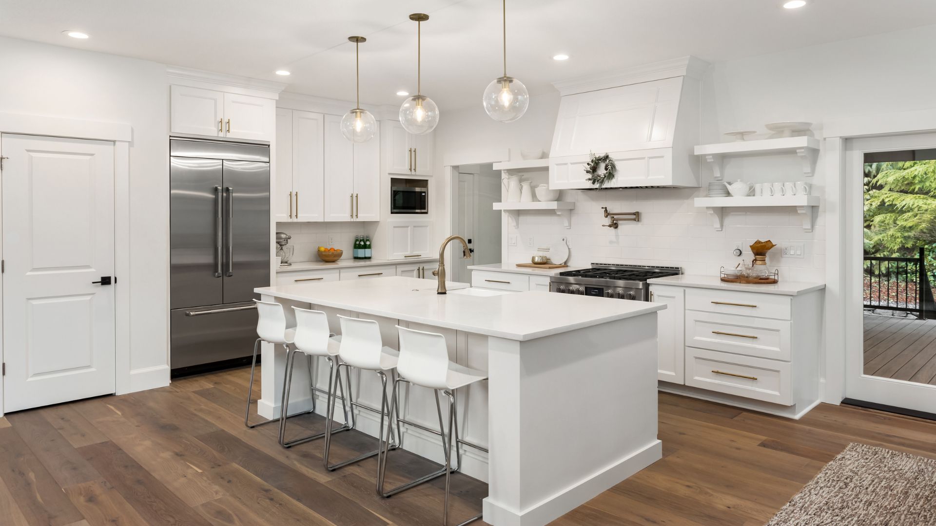 A large kitchen with a center island and white cabinets