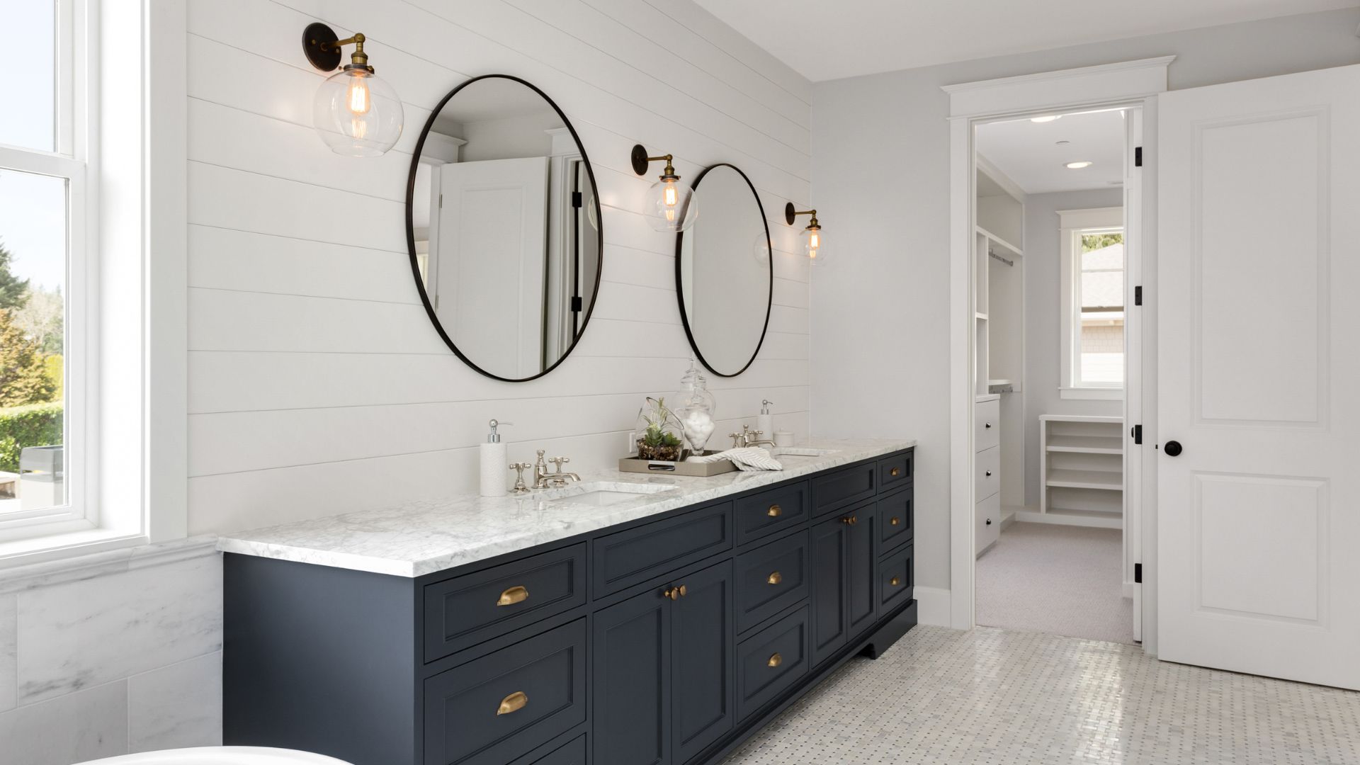 A bathroom with two mirrors and two sinks